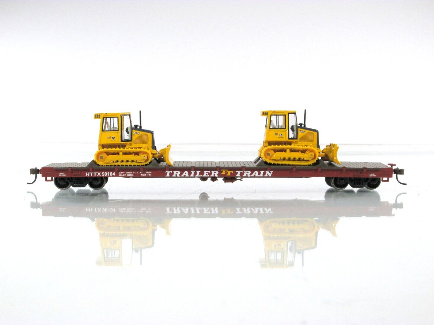 HO Scale ***TRAILER TRAIN*** 50' Flat Car w/ John Deere Dozers --- Athearn 81934