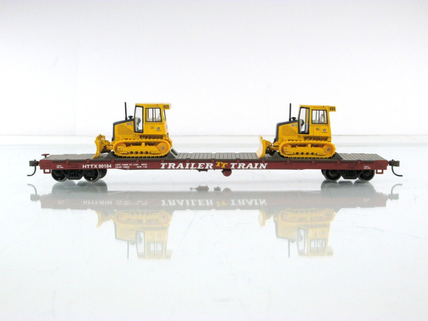 HO Scale ***TRAILER TRAIN*** 50' Flat Car w/ John Deere Dozers --- Athearn 81934